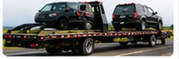 Cars secured on a flatbed tow truck