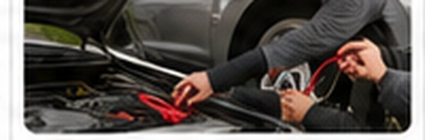 Technician connecting jumper cables