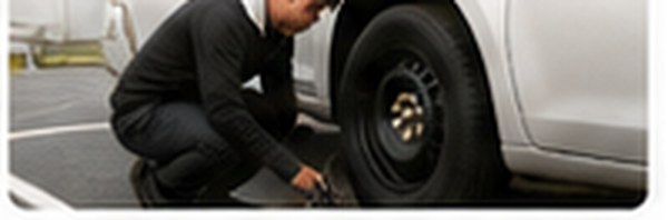 Technician changing a tire at the roadside